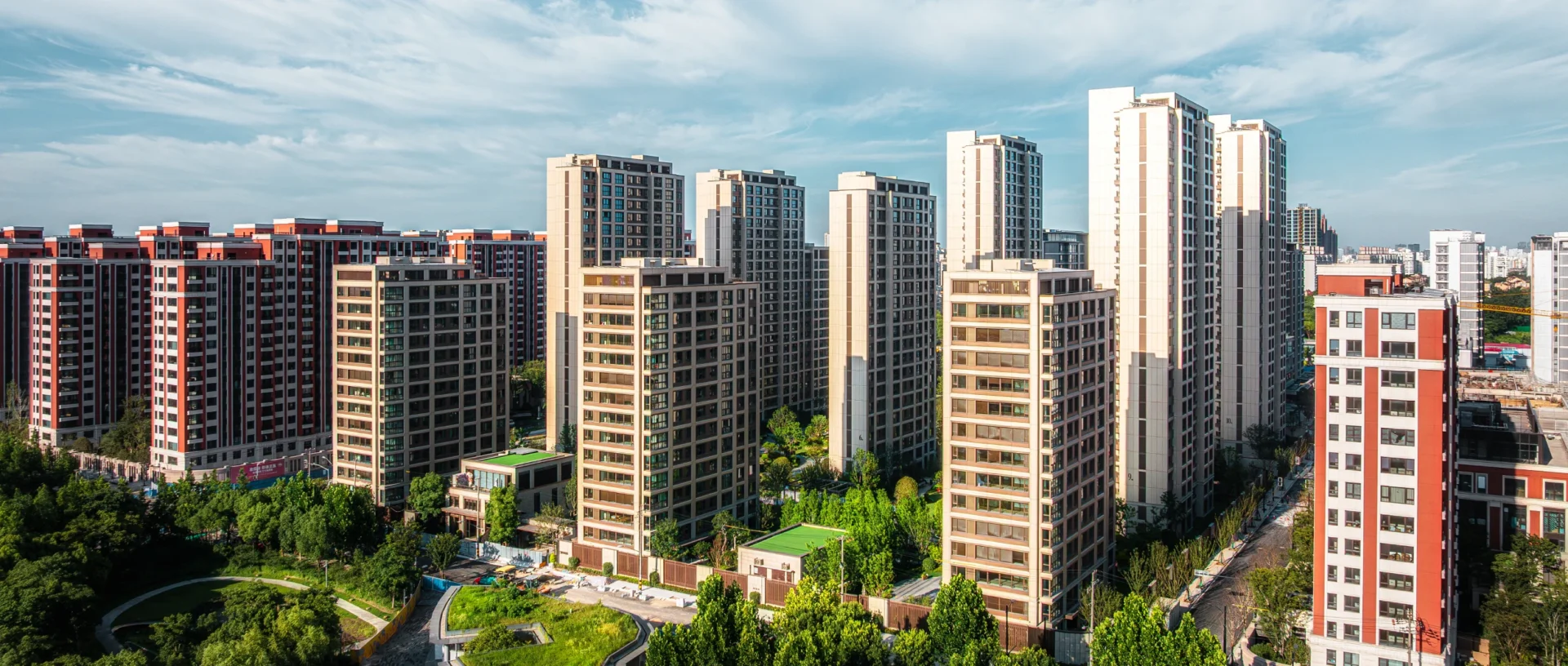 High-rise apartments surrounded by greenery